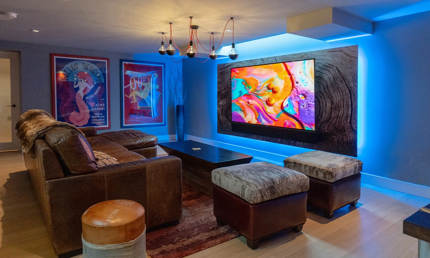 Modern basement living area designed for comfort, featuring art, stylish furniture, and ambient lighting.