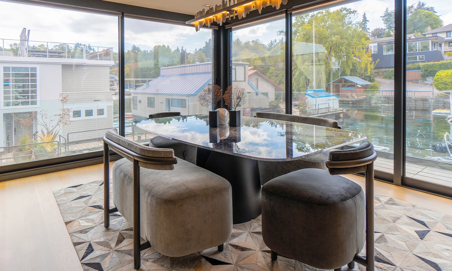 Elegant modern dining area with waterway view, designed by Ariana Adireh in Bellevue.