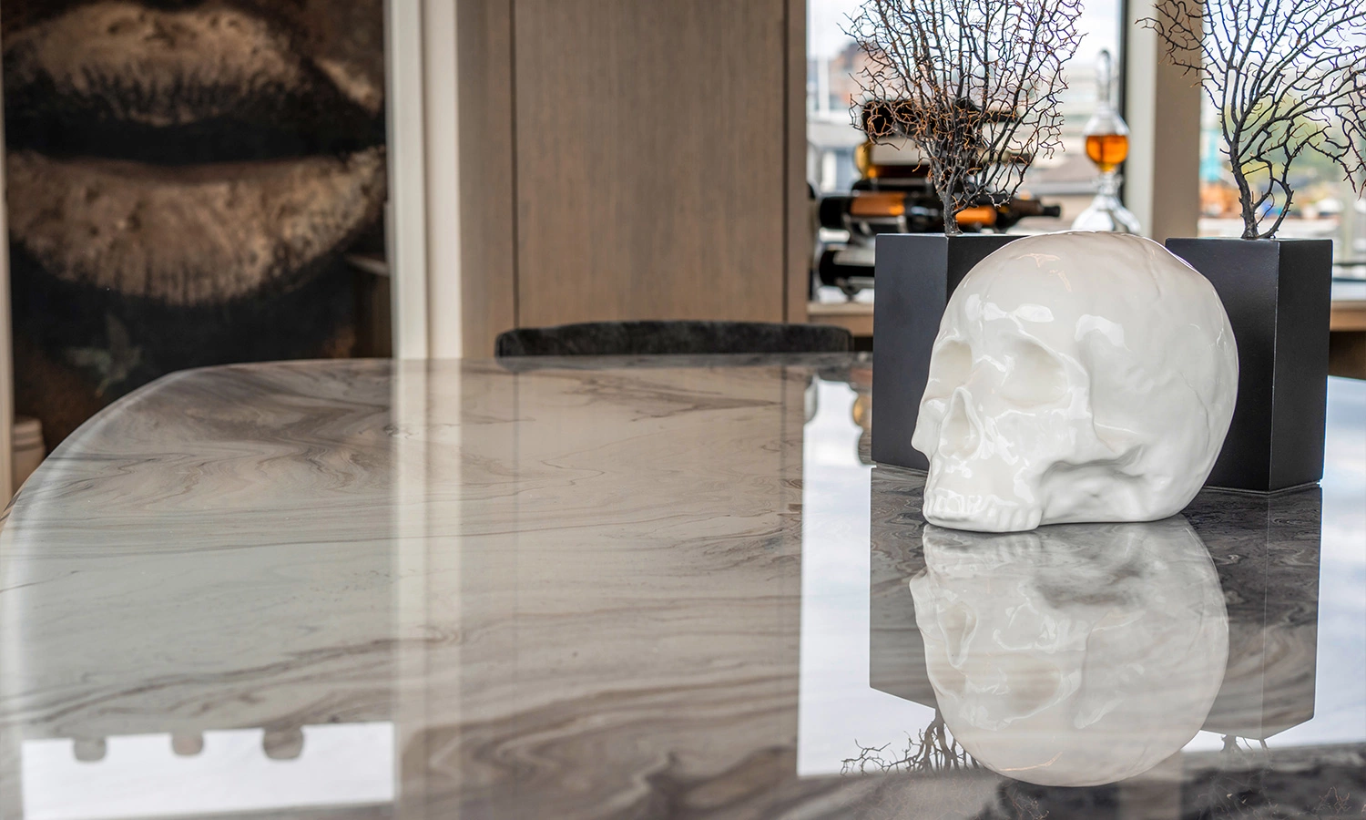 Sophisticated modern interior featuring a marble countertop and striking skull sculpture.