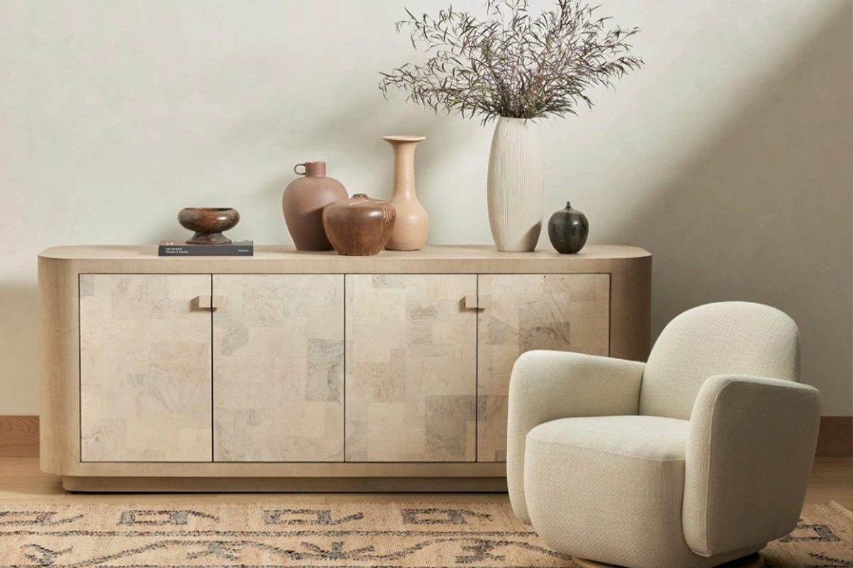 Chic sideboard and cozy armchair enhance modern interior design with inviting decor elements.