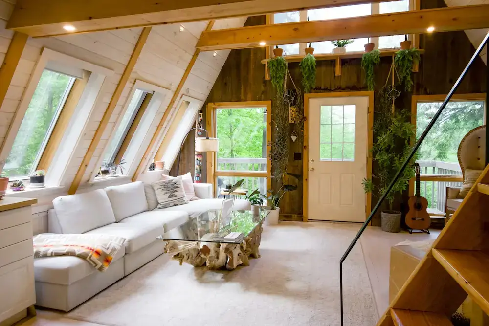 Cozy modern rustic living room with large windows, natural light, and inviting decor.