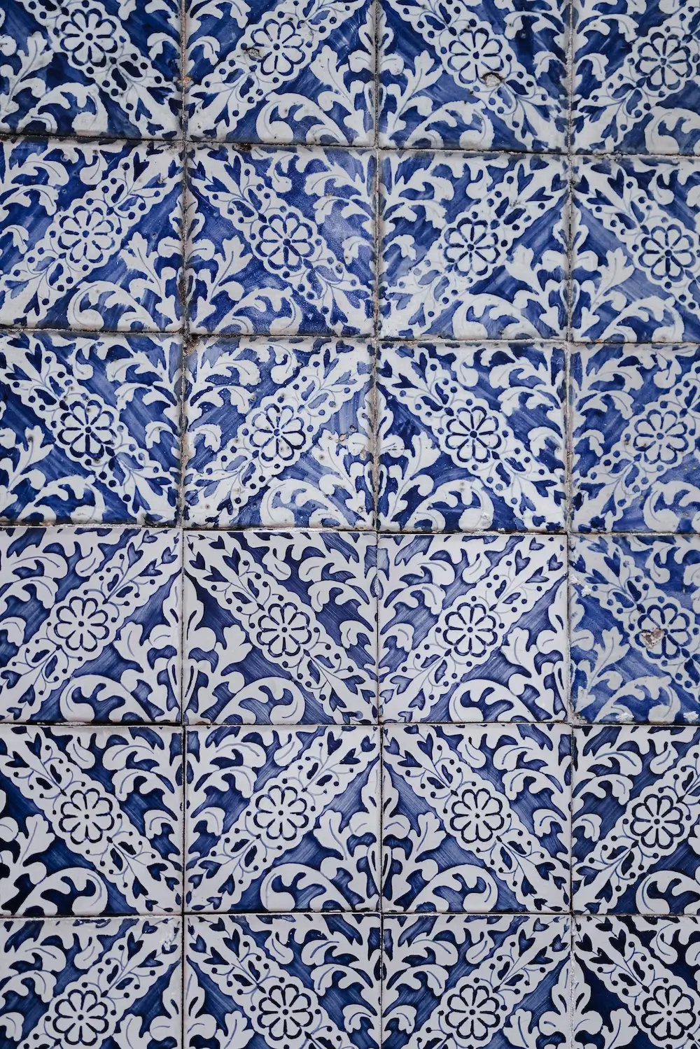 Intricate blue and white tile pattern showcasing elegant geometric and floral designs.