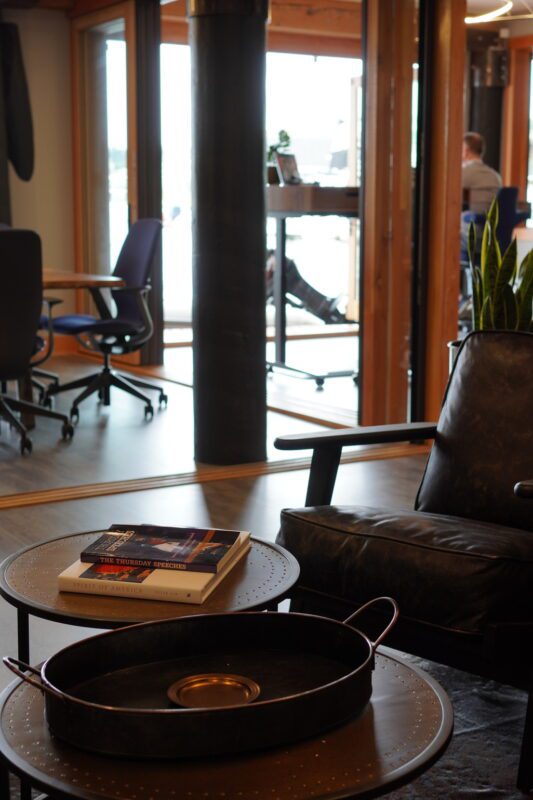 Stylish modern workspace featuring cozy seating, natural light, and collaborative design elements.