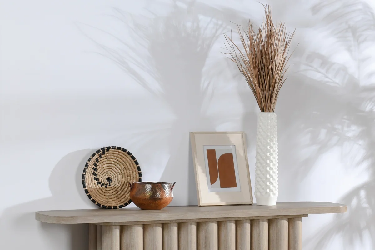 Stylish textured tabletop decor featuring ceramics, basket, and artwork for modern interiors.