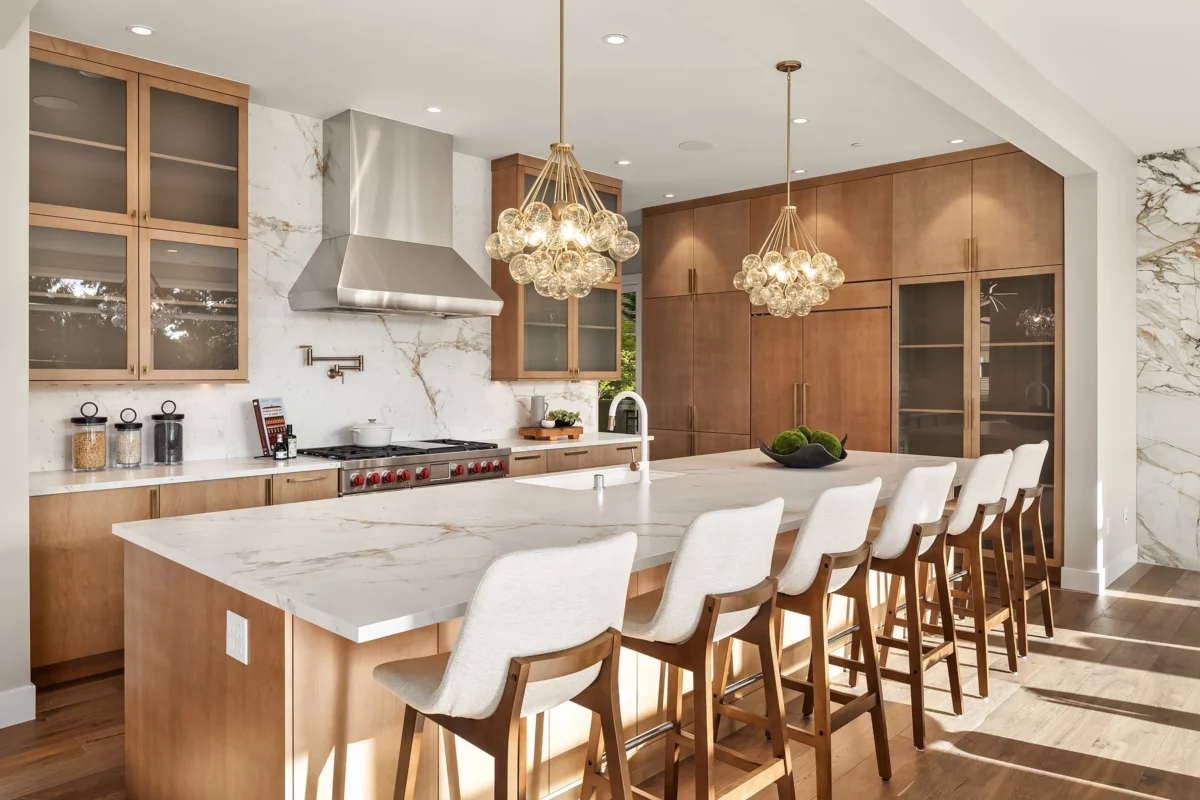 Stylish modern kitchen featuring a marble island and warm wood cabinetry for elegant living.