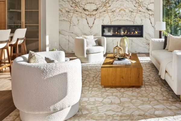 Stylish modern living room featuring a cozy fireplace, elegant decor, and natural light.