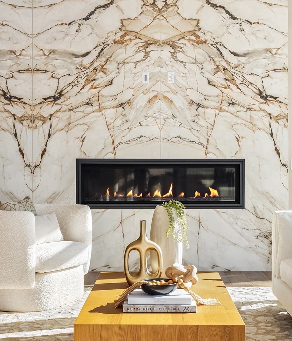 Stylish modern living room featuring a marble fireplace and elegant furnishings for comfort.