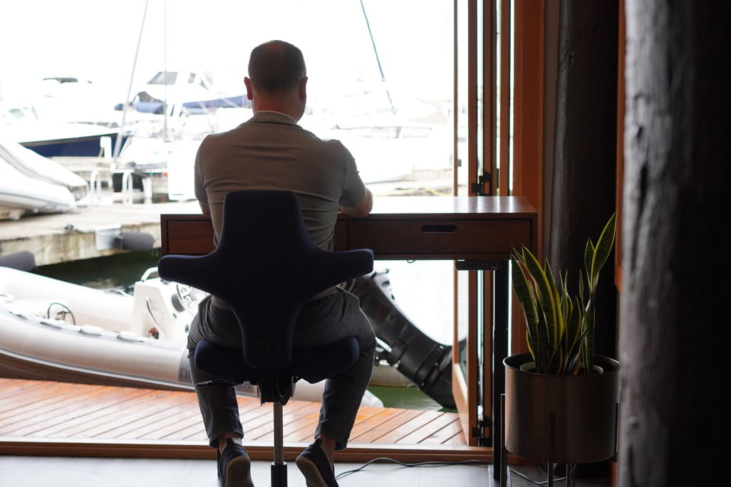 Serene workspace by the marina, blending modern design with calming waterfront views.