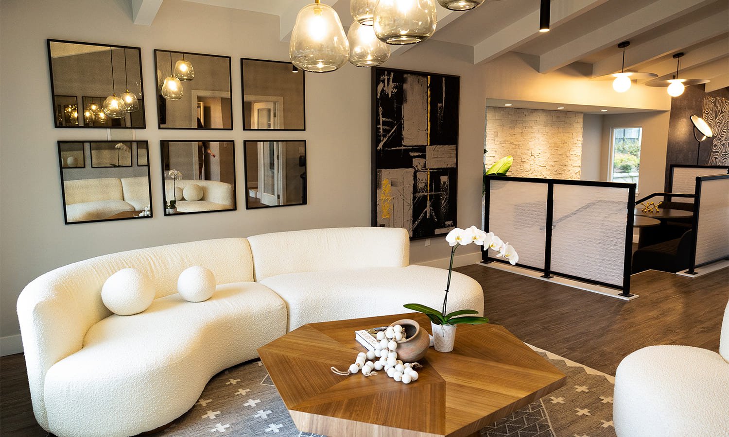 Stylish modern living room featuring a curved sofa and striking abstract art.