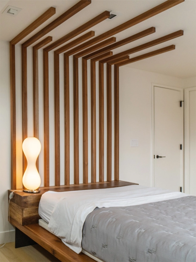 Modern minimalist bedroom featuring a wooden slat headboard and calming color palette.