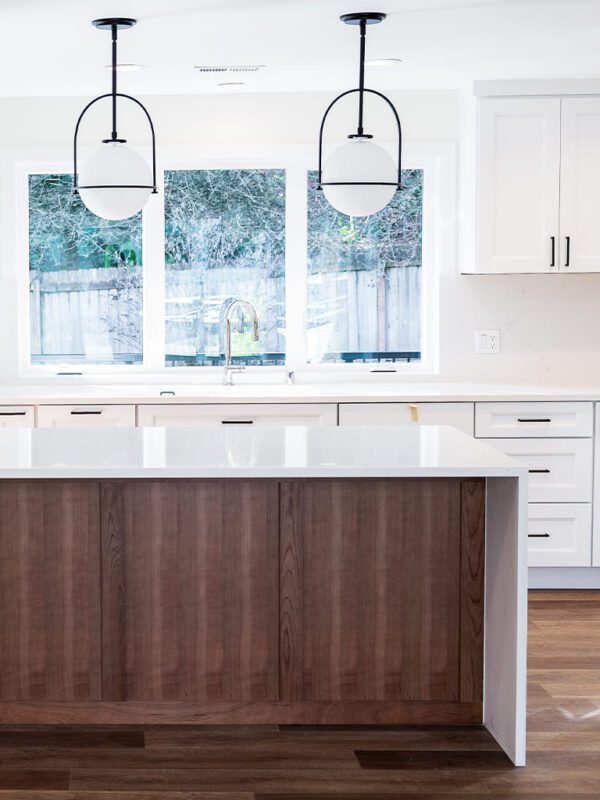 Elegant modern kitchen with bright aesthetics, white countertops, and warm wood accents.