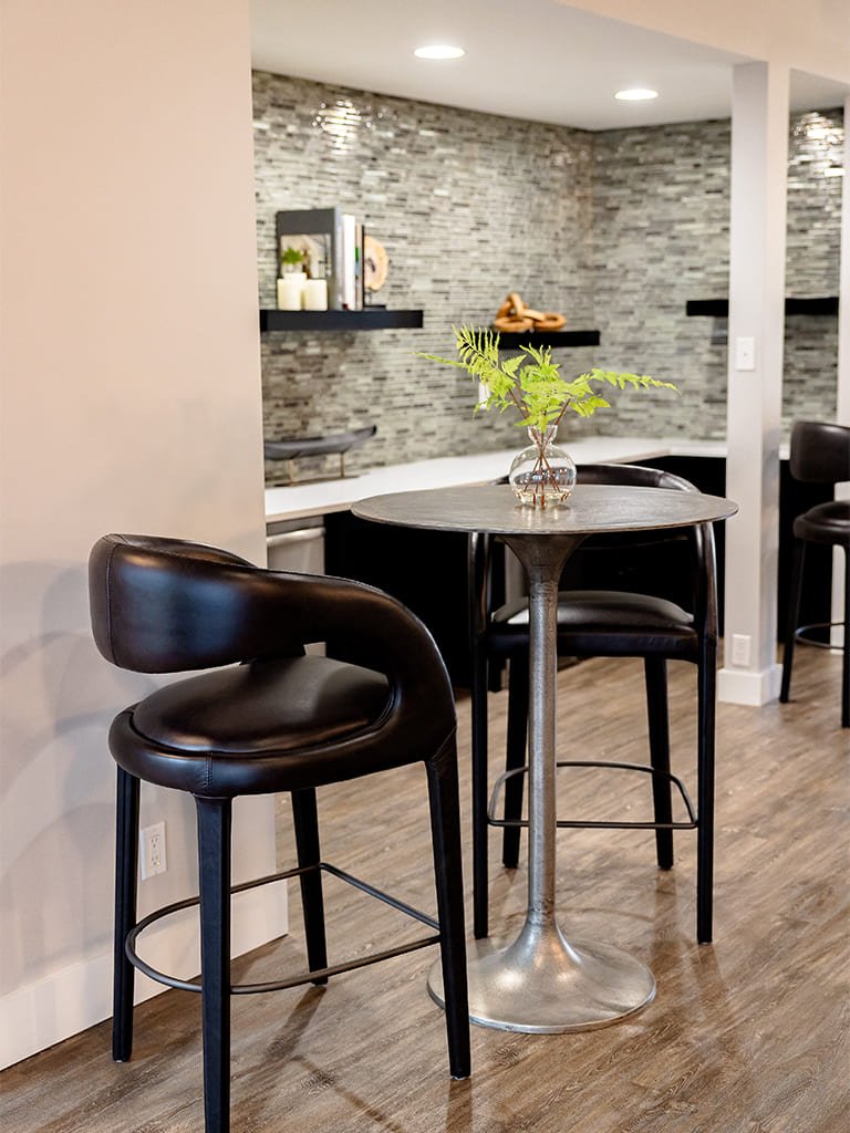 Modern kitchen featuring a stylish dining area with elegant furnishings and warm decor.