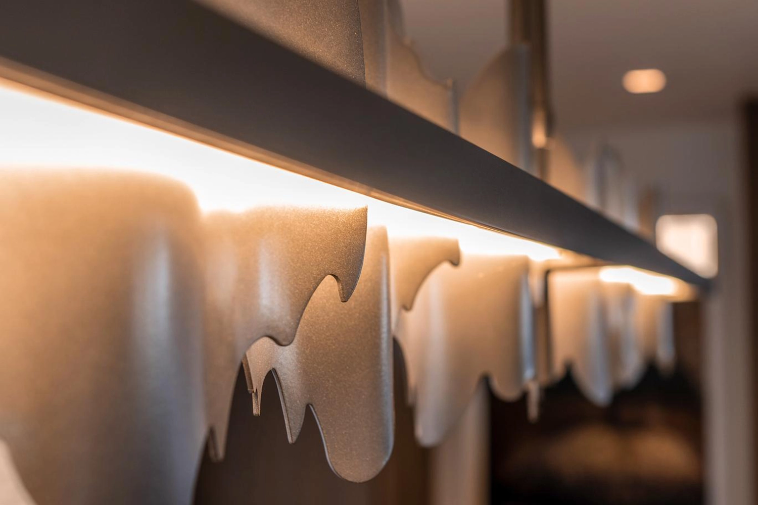 Artistic wave-inspired lighting fixture enhancing modern interiors with warm, inviting illumination.