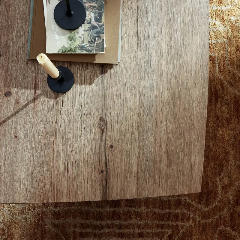 Warm minimalist coffee table decor with books and candle for a cozy atmosphere.