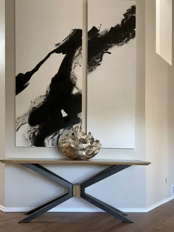 Contemporary console table paired with striking abstract art for a modern interior design.