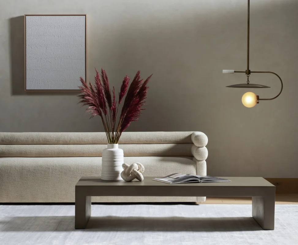 Chic minimalist living room featuring a plush sofa and pampas grass decor.