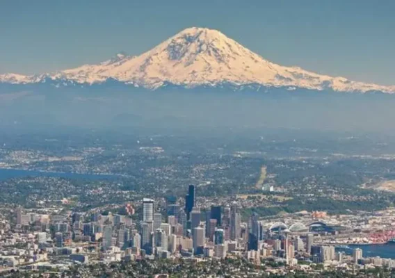 Seattle skyline featuring the iconic Mt. Rainier in a stunning aerial view.