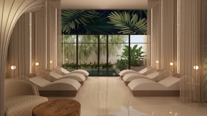 Tranquil spa room with natural light, lush views, and inviting lounge chairs for relaxation.