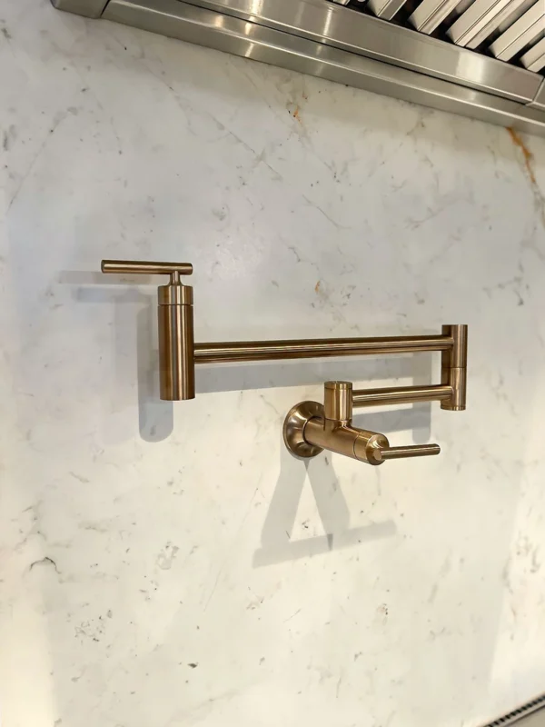 Sleek brushed bronze kitchen faucet on elegant marble countertop, combining modern style and functionality.