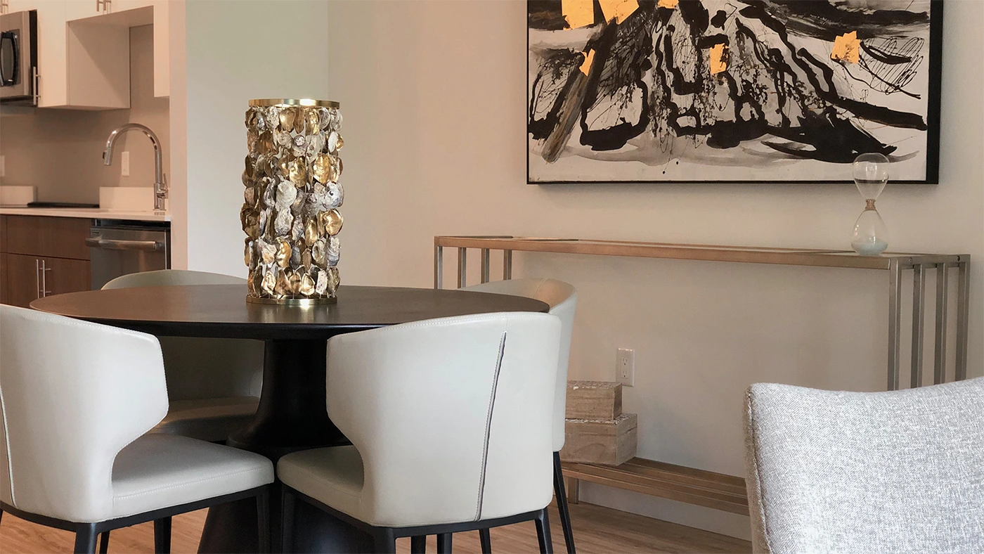 Modern dining area featuring a round table, elegant chairs, and stylish decor elements.