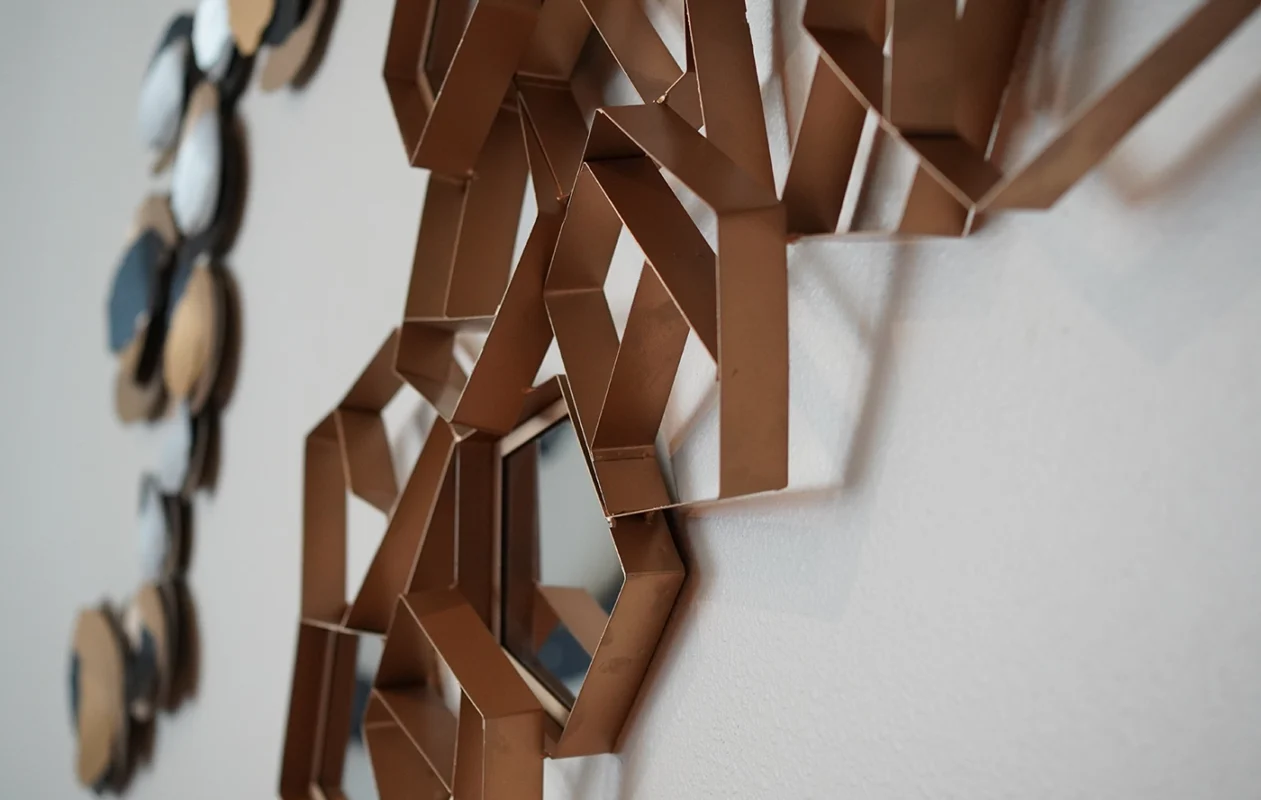 Striking geometric metal wall art in bronze, showcasing modern craftsmanship and dynamic design.