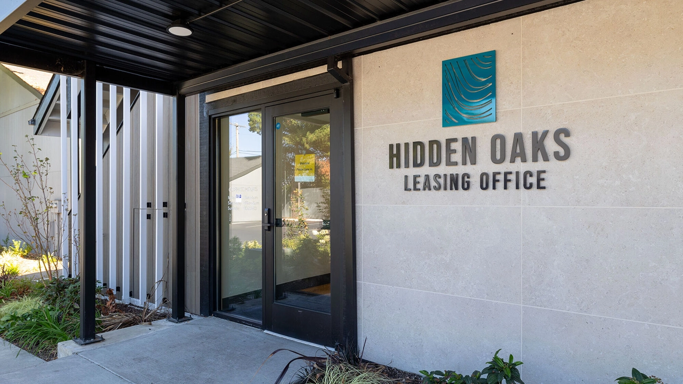 Modern Hidden Oaks Leasing Office entrance with inviting design and natural elements.