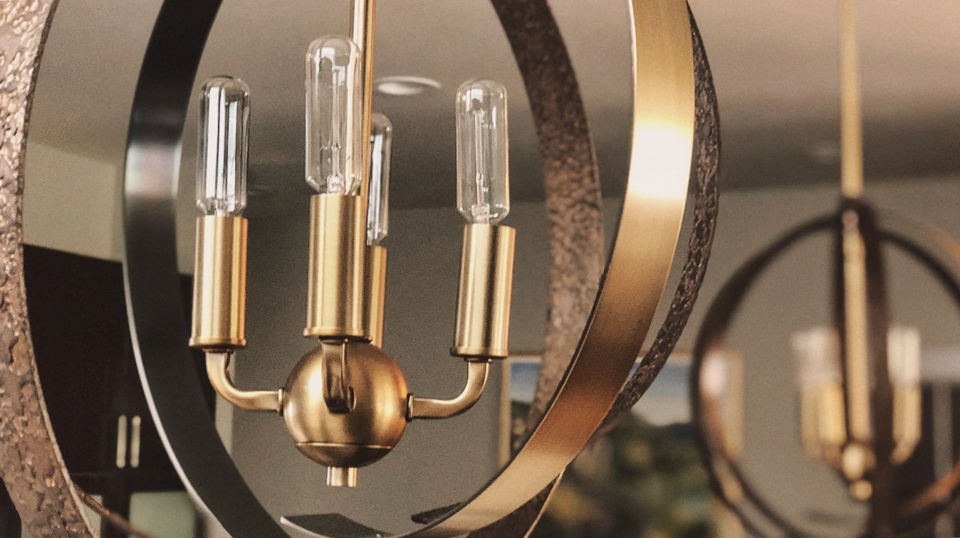 Stylish gold chandelier with Edison bulbs, blending modern and vintage design elements.