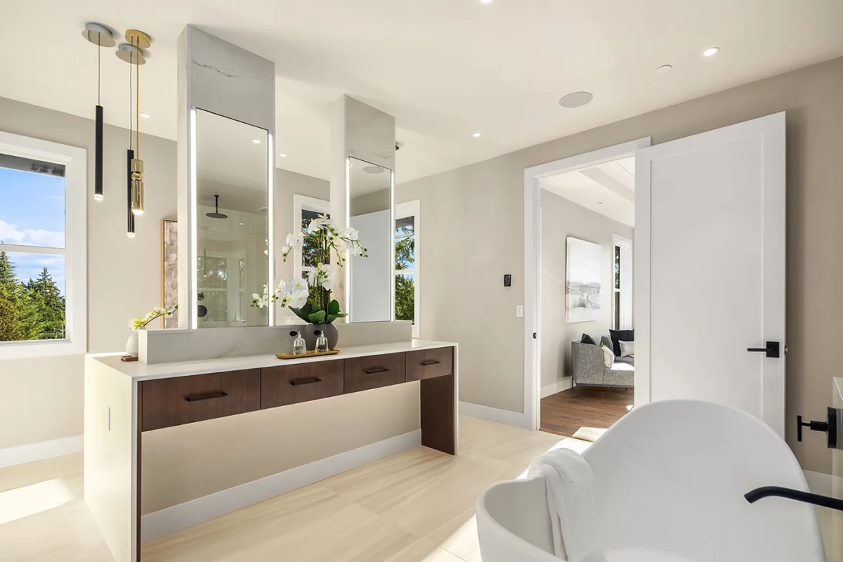 Elegant modern bathroom with a luxurious vanity, freestanding tub, and natural lighting.