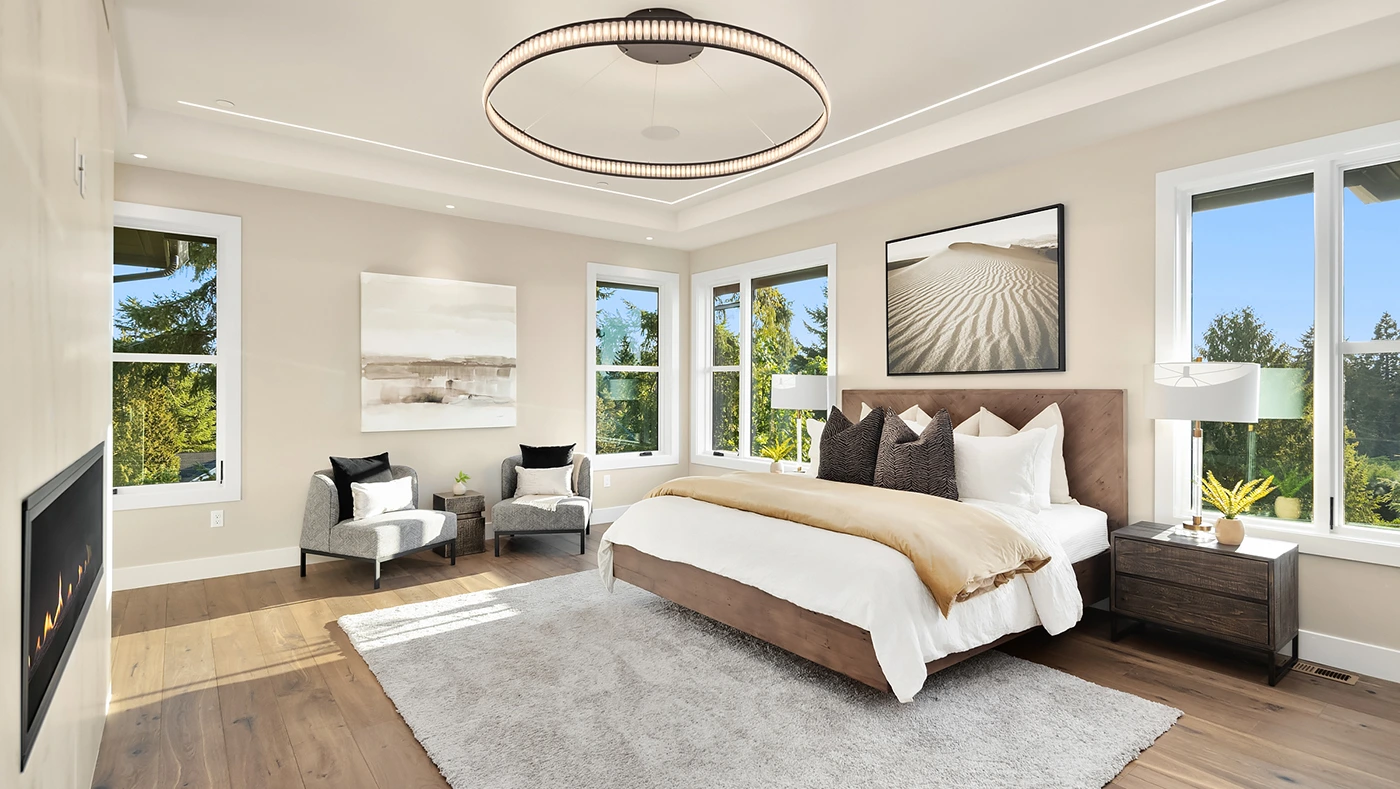 Modern elegant bedroom with natural light, plush bedding, and stylish decor for tranquility.