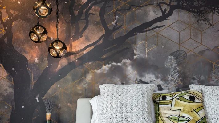 Elegant modern interior featuring abstract tree mural and geometric pendant lights.