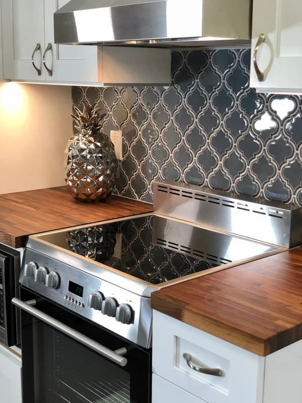 Sleek modern kitchen with stainless steel appliances, wood countertops, and stylish decorative accents.