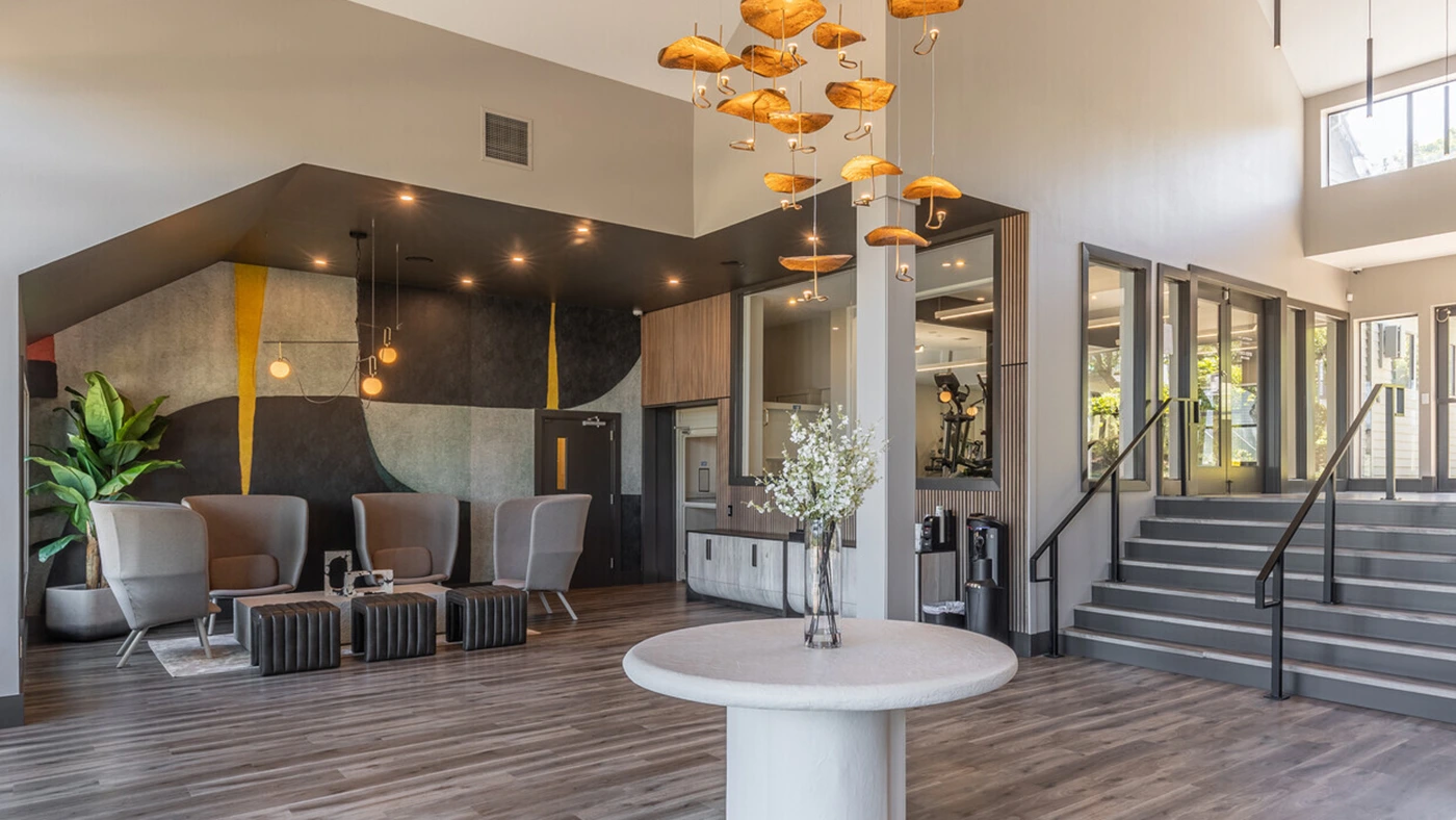 Modern lobby space featuring stylish decor, abstract mural, and inviting seating arrangements.