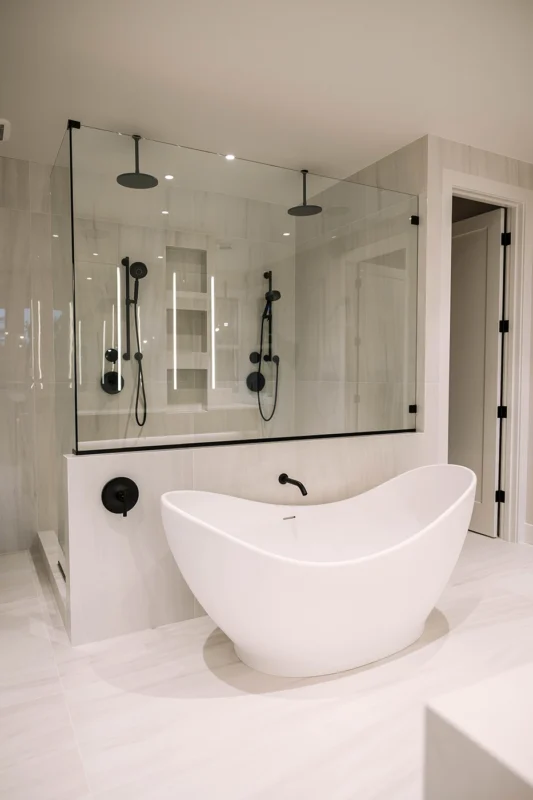 Elegant modern bathroom featuring a freestanding bathtub, spacious shower, and sleek design elements.