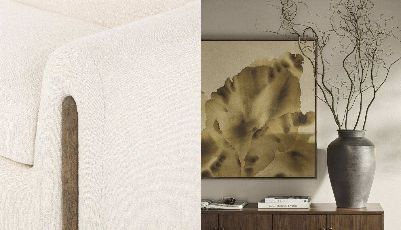 Elegant cream sofa and abstract wall art create a serene modern living space vignette.