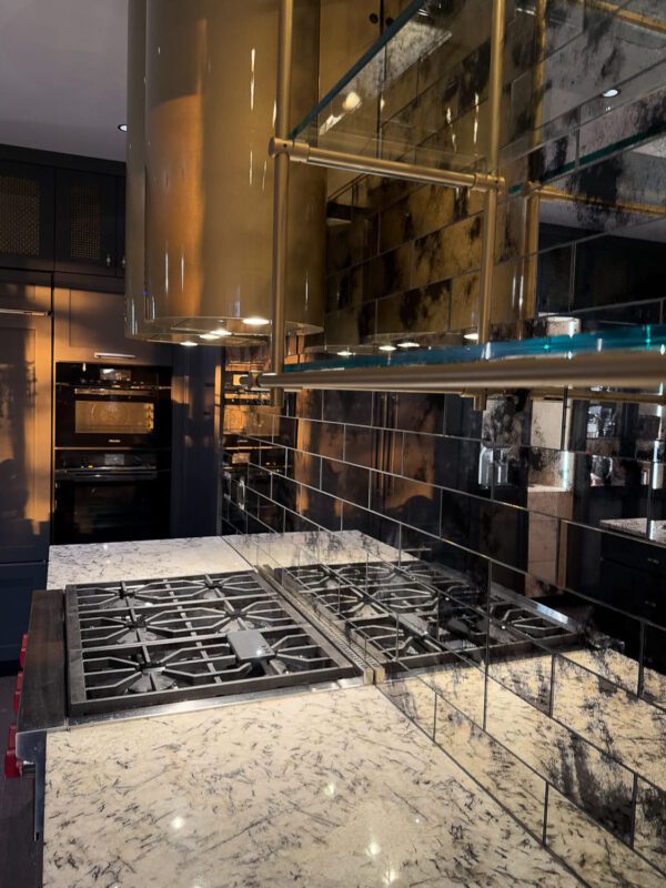 Elegant modern kitchen with marble countertop, sleek cabinetry, and stylish lighting.