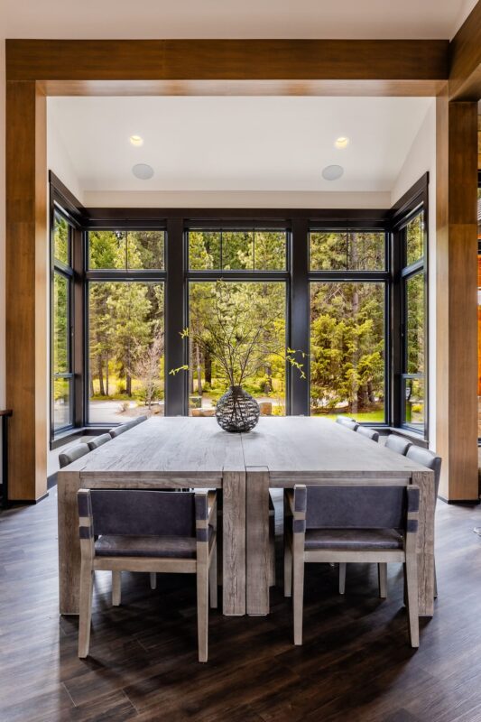 A refined dining area at the Suncadia Grand Retreat, with a spacious table, modern lighting, and tasteful decor, perfect for gatherings.