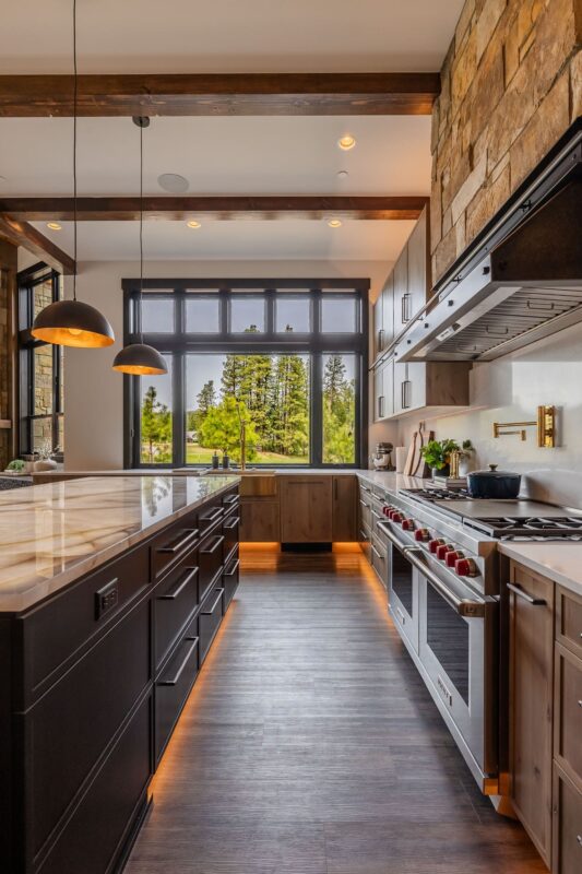 A sleek, gourmet kitchen in the Suncadia Grand Retreat with advanced appliances, expansive countertops, and contemporary design.