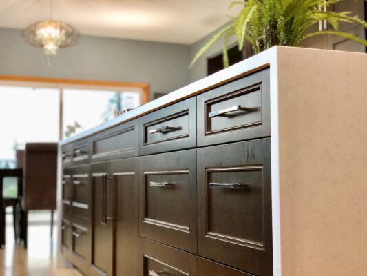 Close-up of a mosaic backsplash with textured tiles, added as a decorative element to warm up a sleek, modern kitchen design.