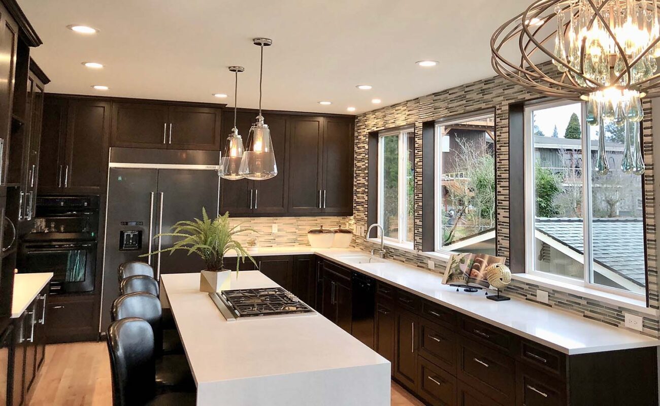 Patty and Bealer standing in their beautifully designed kitchen, smiling and enjoying their personalized, luxury interior space.