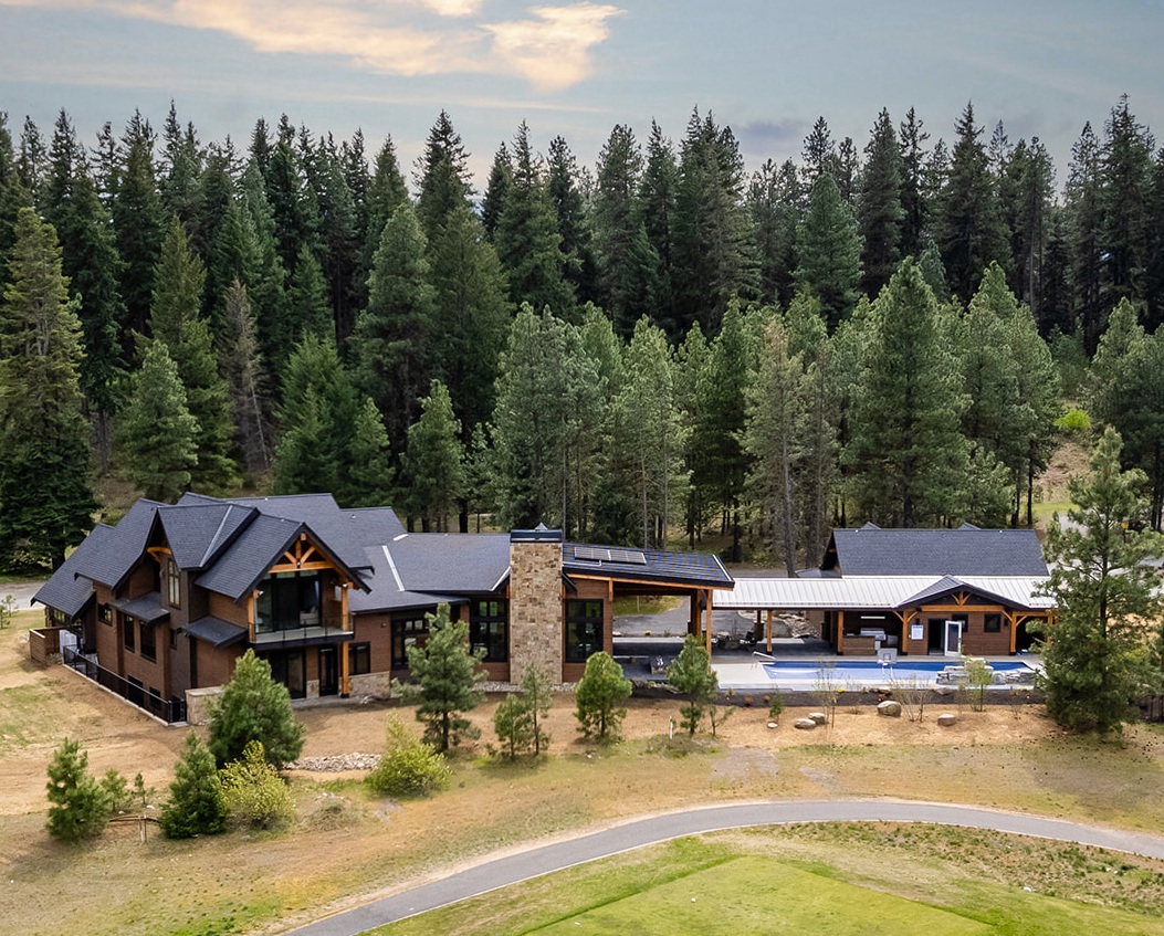 Luxury mountain lodge retreat nestled in nature with stunning architecture and outdoor living space.