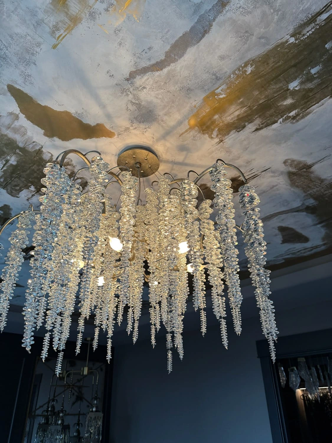 Elegant chandelier design featuring cascading crystals enhances sophisticated interior lighting and decor.