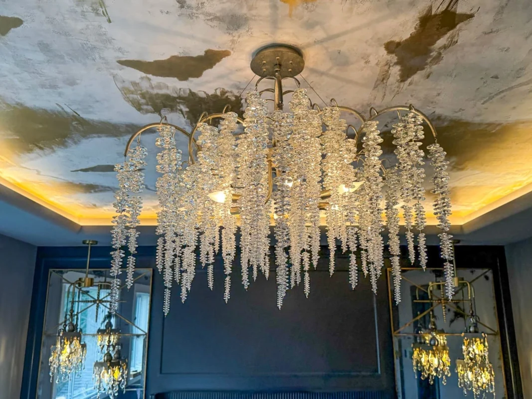 Elegant chandelier with cascading crystals enhances a stylish interior with luxurious decor.