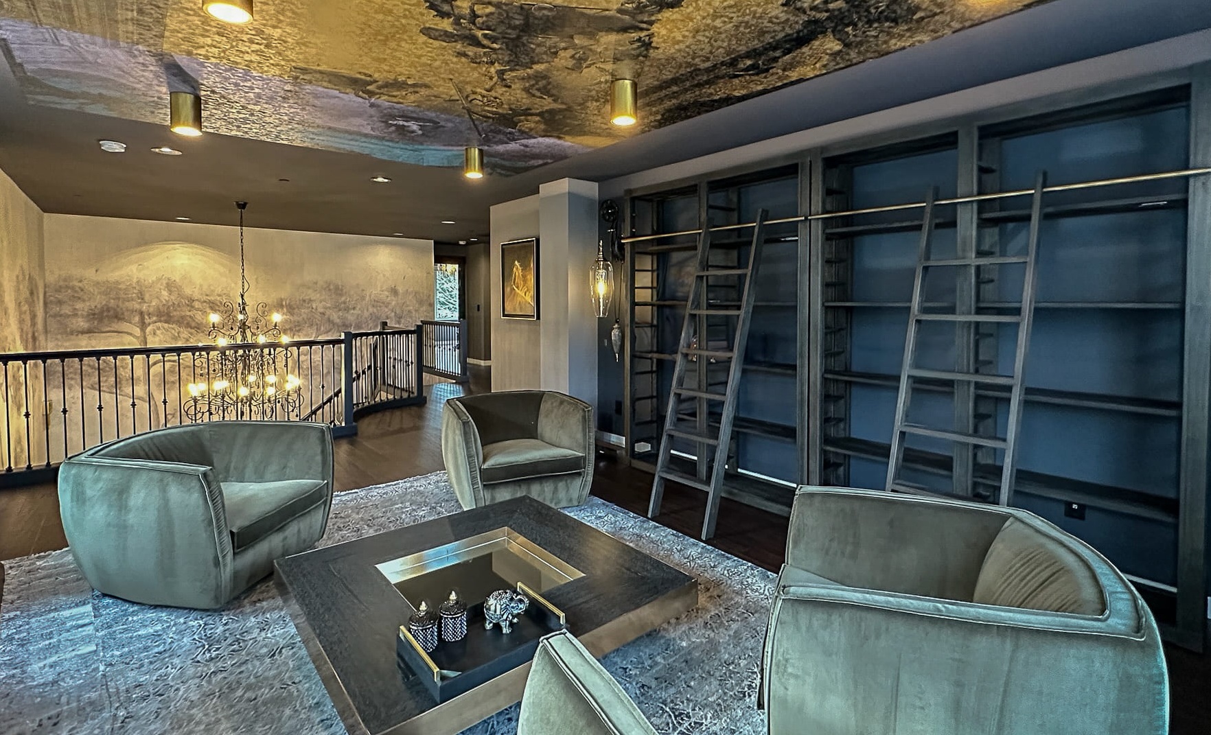 Elegant modern living space with dark blue walls, plush chairs, and stylish bookshelf.
