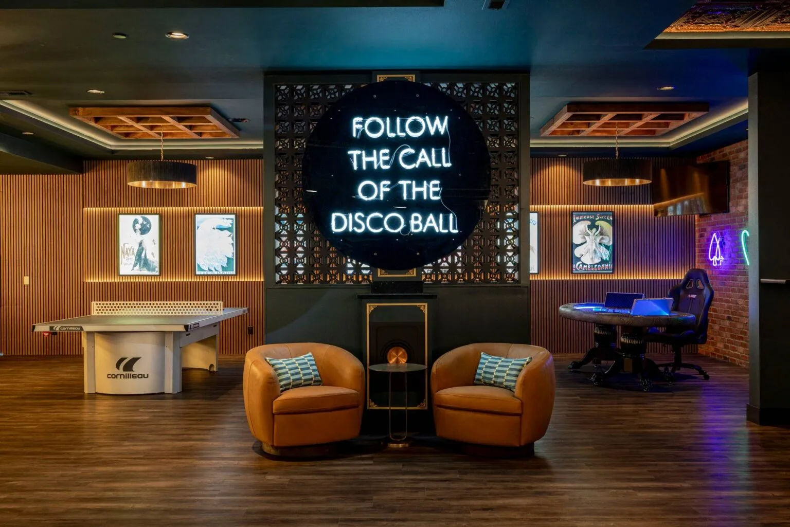Modern lounge area with neon "Follow the Call of the Disco Ball" sign designed by Ariana Designs & Interiors showcasing Clyhe Hill interior design expertise