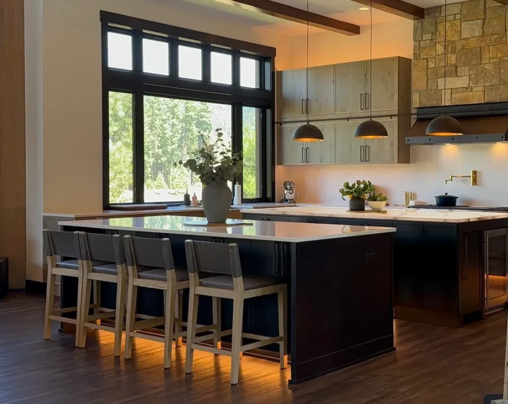 Custom black kitchen island with LED cabinet lighting designed by Ariana Designs & Interiors, an expert interior designer in Clyde Hill